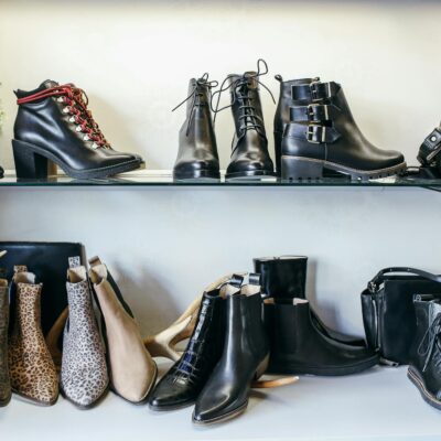 Diverse assortment of leather and animal print boots elegantly displayed on shelves for fashion enthusiasts.