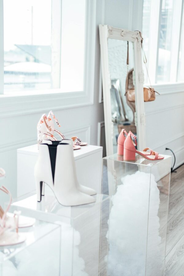 Modern shoe collection elegantly displayed in a chic boutique with natural lighting.