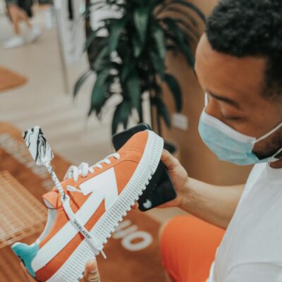 Young man in store checking out colorful sneaker, Las Vegas.
