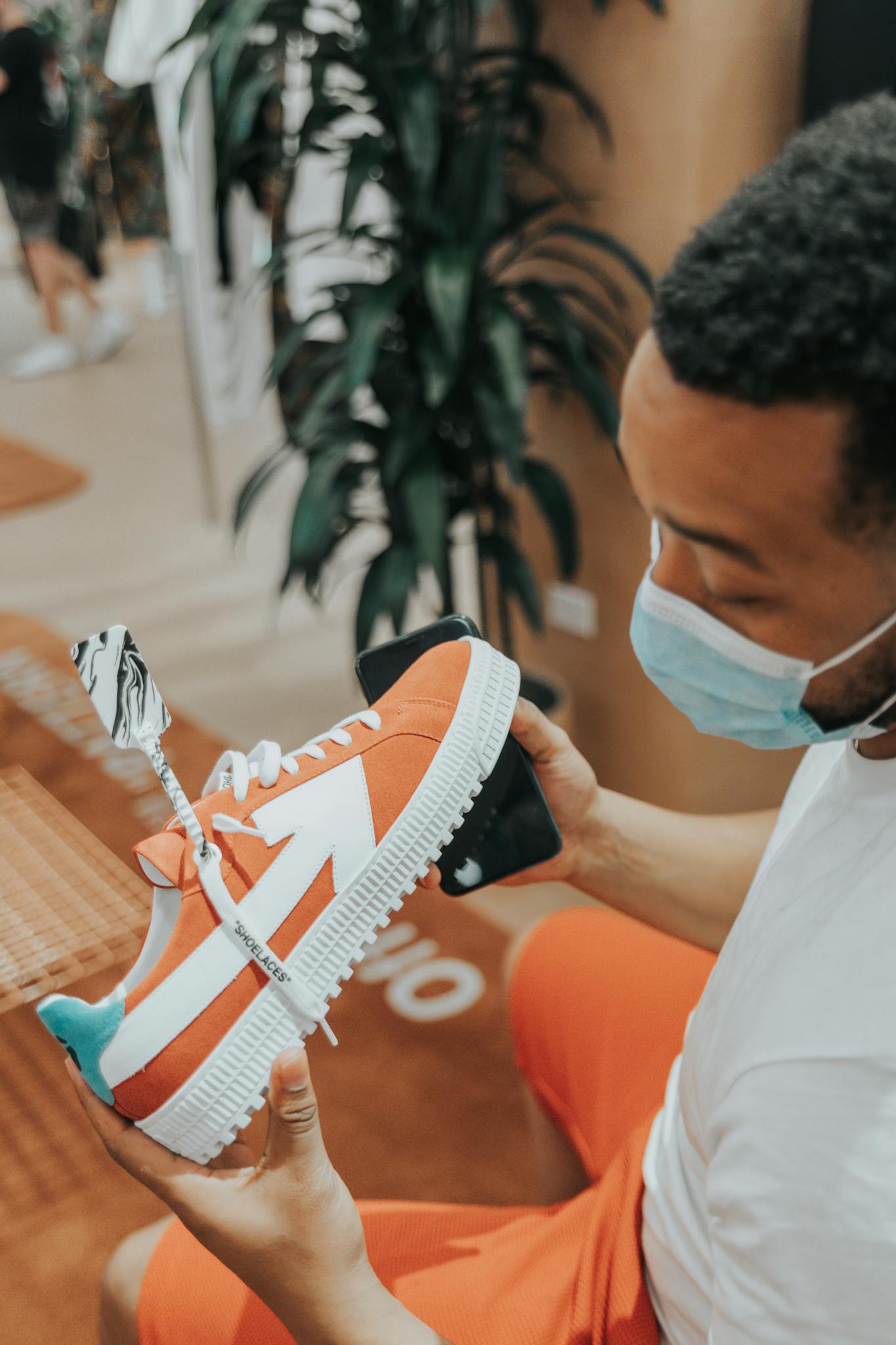 Young man in store checking out colorful sneaker, Las Vegas.
